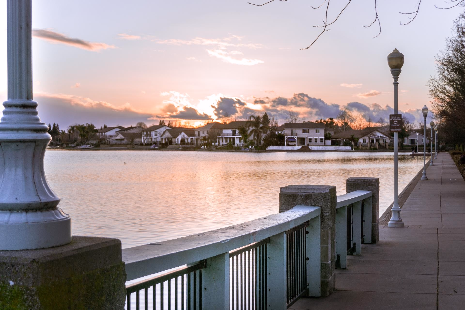 Lakeside walk with lamp posts at sunset in Elk Grove