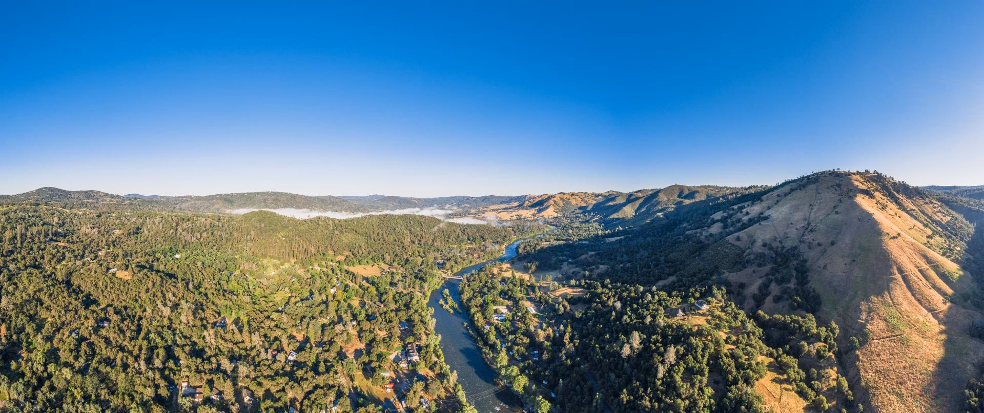 Panorama of wooded hills and river canyon
